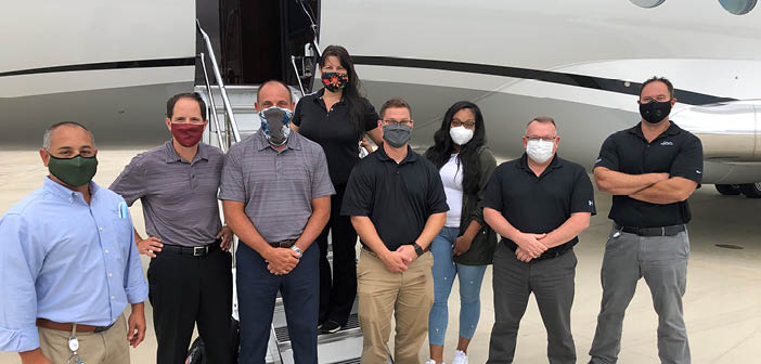 The EIS team (left and right), standing with a group that visited the SD facility recently for instruction