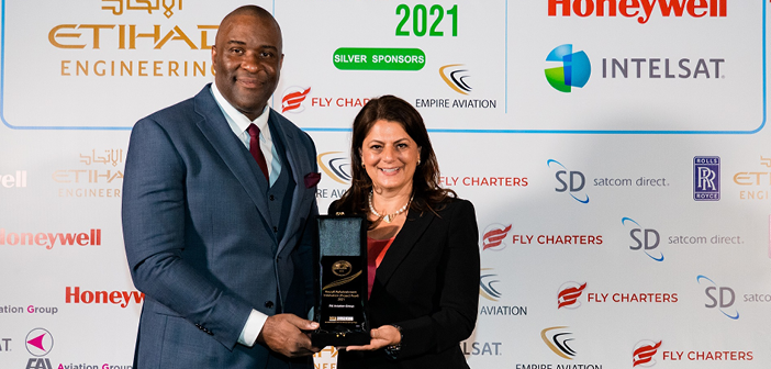 FAI’s Barbara Baumgartner collects the award from Kenneth Mitchen, Aviation Awards gala organiser