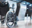 A wheelchair parked at an airport check-in desk