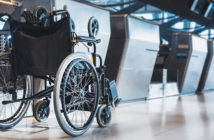 A wheelchair parked at an airport check-in desk