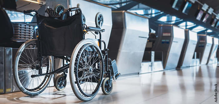 A wheelchair parked at an airport check-in desk