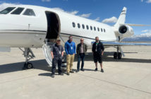 The Falcon STC install team of four, standing in front of an aircraft on the tarmac