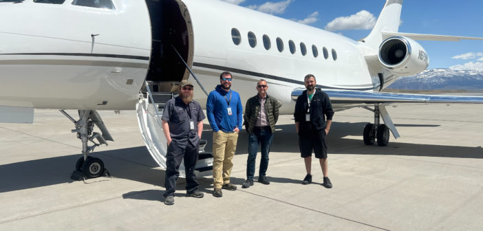 The Falcon STC install team of four, standing in front of an aircraft on the tarmac