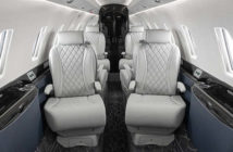 The interior of the Citation 750 overhauled by Duncan Aviation – featuring grey seats with quilted double-stitched diamond pattern inserts; navy lower sidewalls; black composite ebony veneer; satin chrome plating; and a dark carpet with light accents