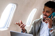 A passenger making a voice call in a business jet