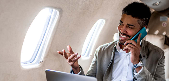 A passenger making a voice call in a business jet