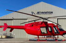 A red Bell 407GXi helicopter delivered to Nautilus Aviation, pictured outside a Jet Aviation hangar