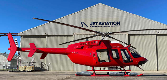 A red Bell 407GXi helicopter delivered to Nautilus Aviation, pictured outside a Jet Aviation hangar