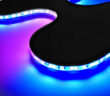 The Curve flex light displayed with blue and pink sections, bending around curves
