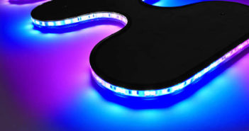 The Curve flex light displayed with blue and pink sections, bending around curves