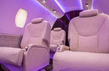 Business aircraft interior with light purple mood lighting