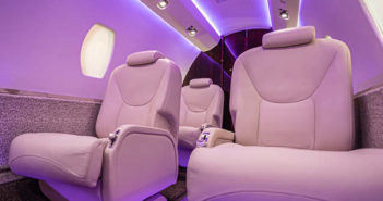 Business aircraft interior with light purple mood lighting