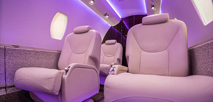 Business aircraft interior with light purple mood lighting