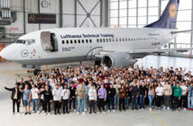 Lufthansa Technik apprentices in front of an aircraft in hangar