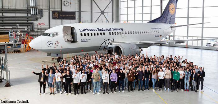 Lufthansa Technik apprentices in front of an aircraft in hangar
