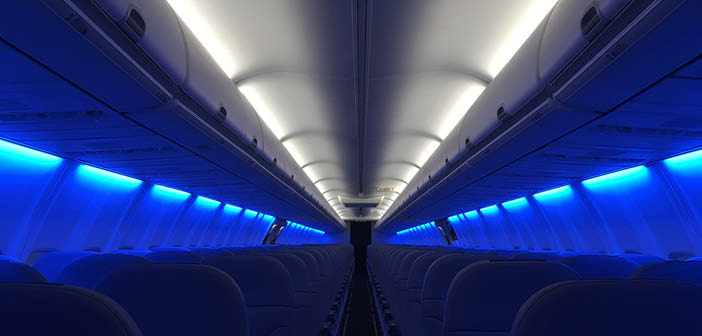 Aircraft cabin with blue and white lighting