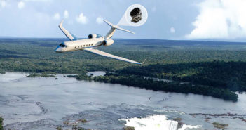 Business jet flying over landscape, with cutout of installed equipment