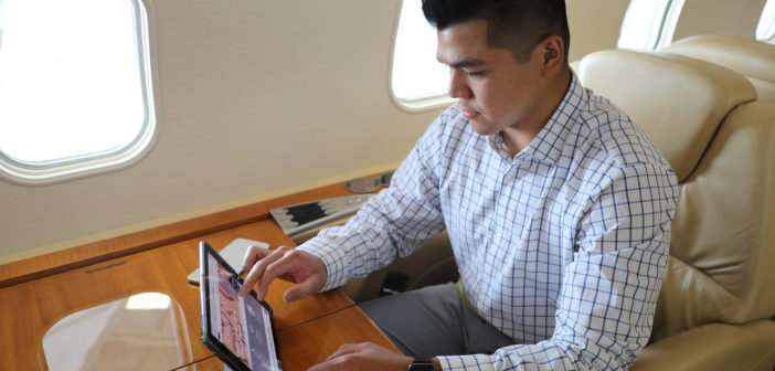 Man using tablet on business jet
