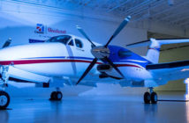 Turboprop in hangar with '100' sign