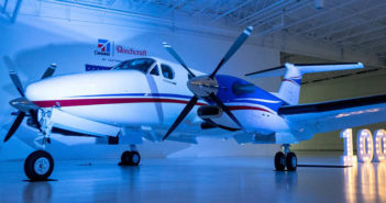 100th delivery for Beechcraft King Air 360 Turboprop in hangar with '100' sign