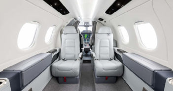 Business jet interior with view to cockpit