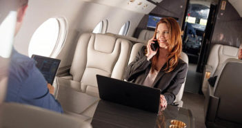 Passengers using phones and tablets on business jet