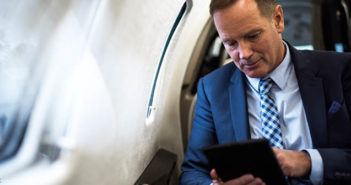 Man using tablet in business jet