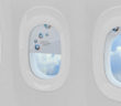 three aircraft windows with shades fully, partially and completely drawn