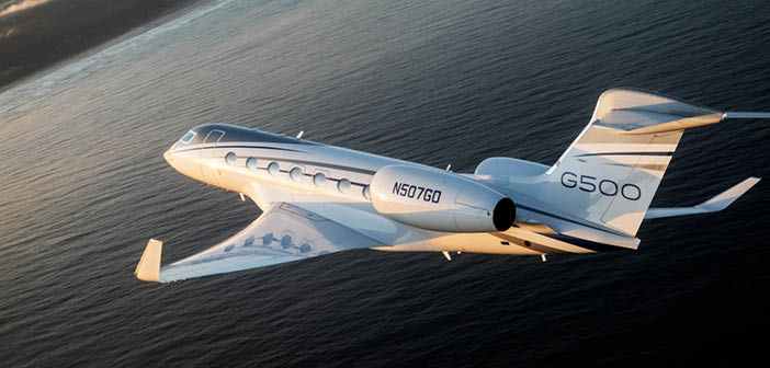 Business jet in flight over water