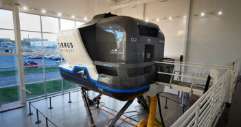 Second FAA-certified Vision Jet simulator for Cirrus Aircraft A simulator is sitting in a room with a lot of windows